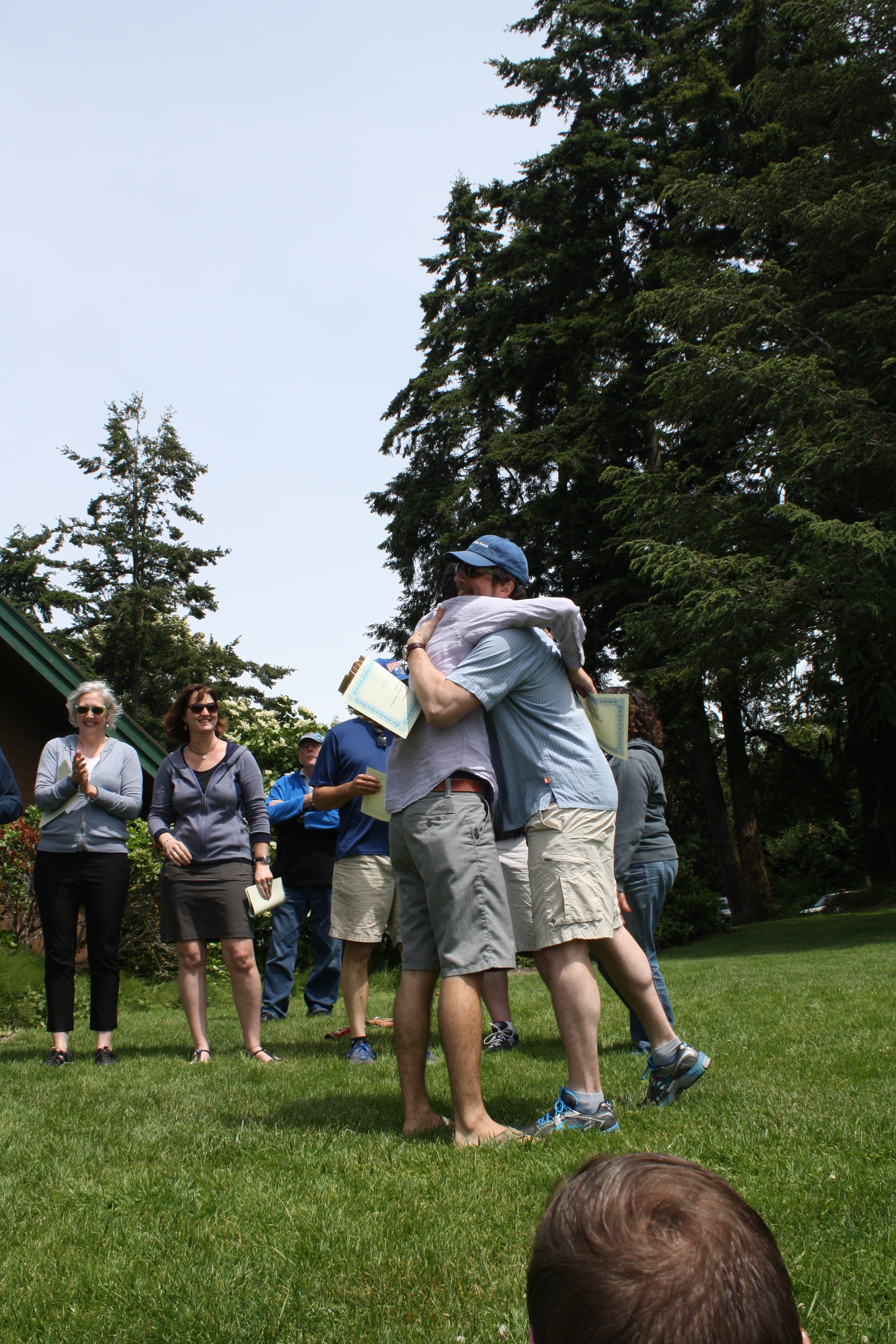Stephen Howie embraces a student at the department picnic.