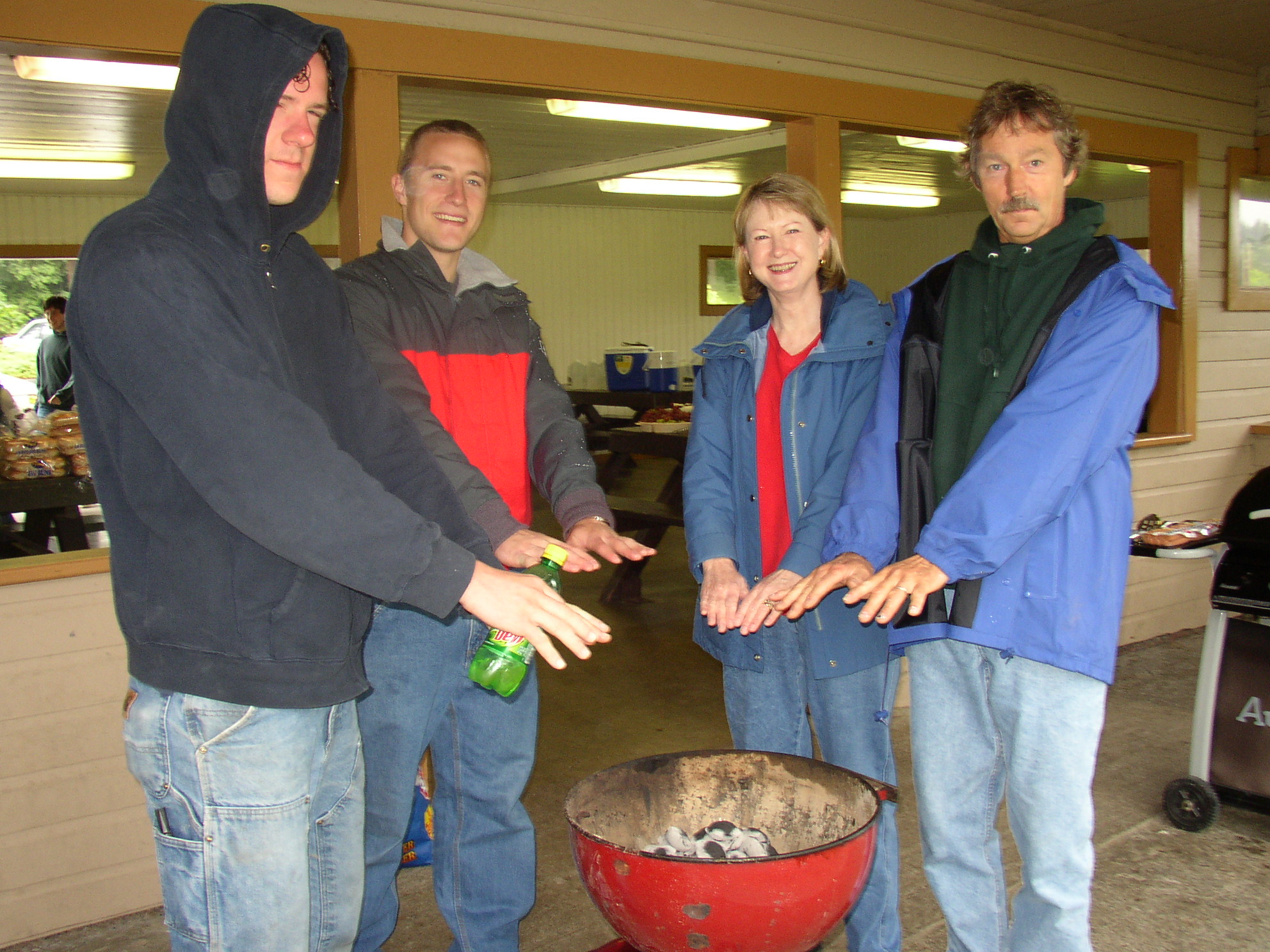 Matthew Anderson, Shearlean Duke and Tim Pilgrim keep warm by the grill.