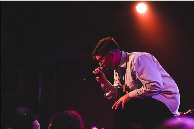 Casey Gainor singing to a crowd at a concert.