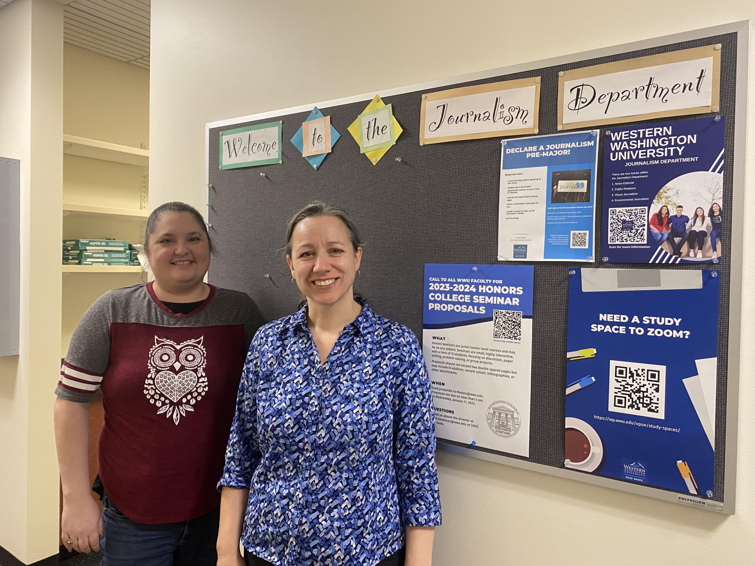 Dalton and van Pelt stand side by side at the entrance corridor to the journalism department offices