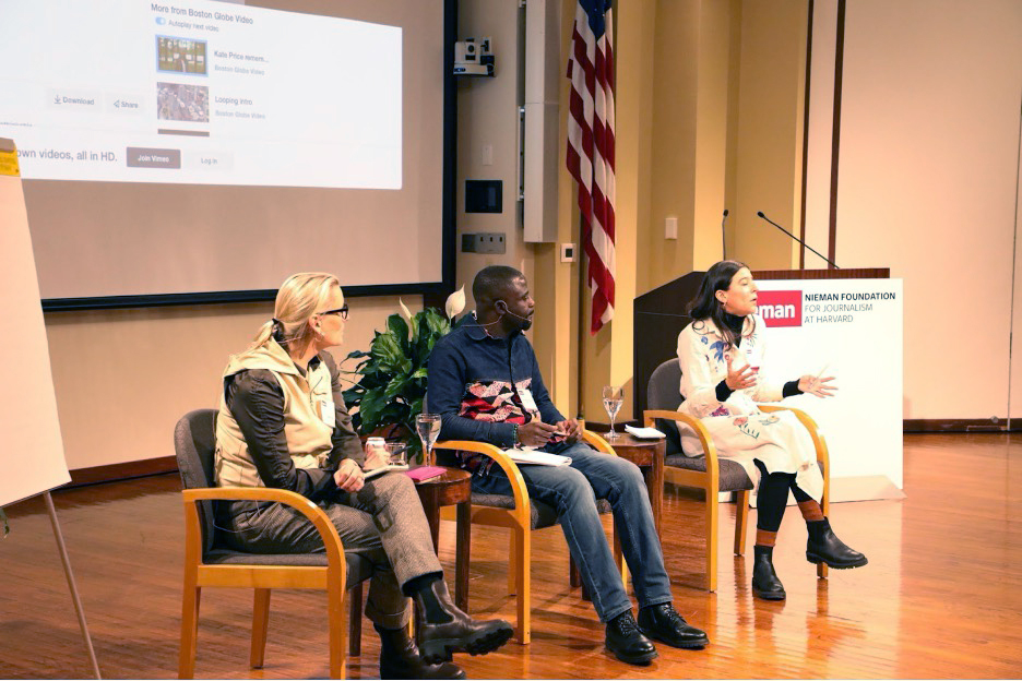 Three journalists sitting in chairs discuss interview techniques in front of an audience.