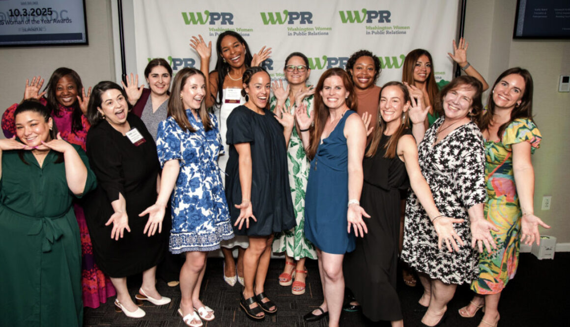 Many women smile and pose for the camera.