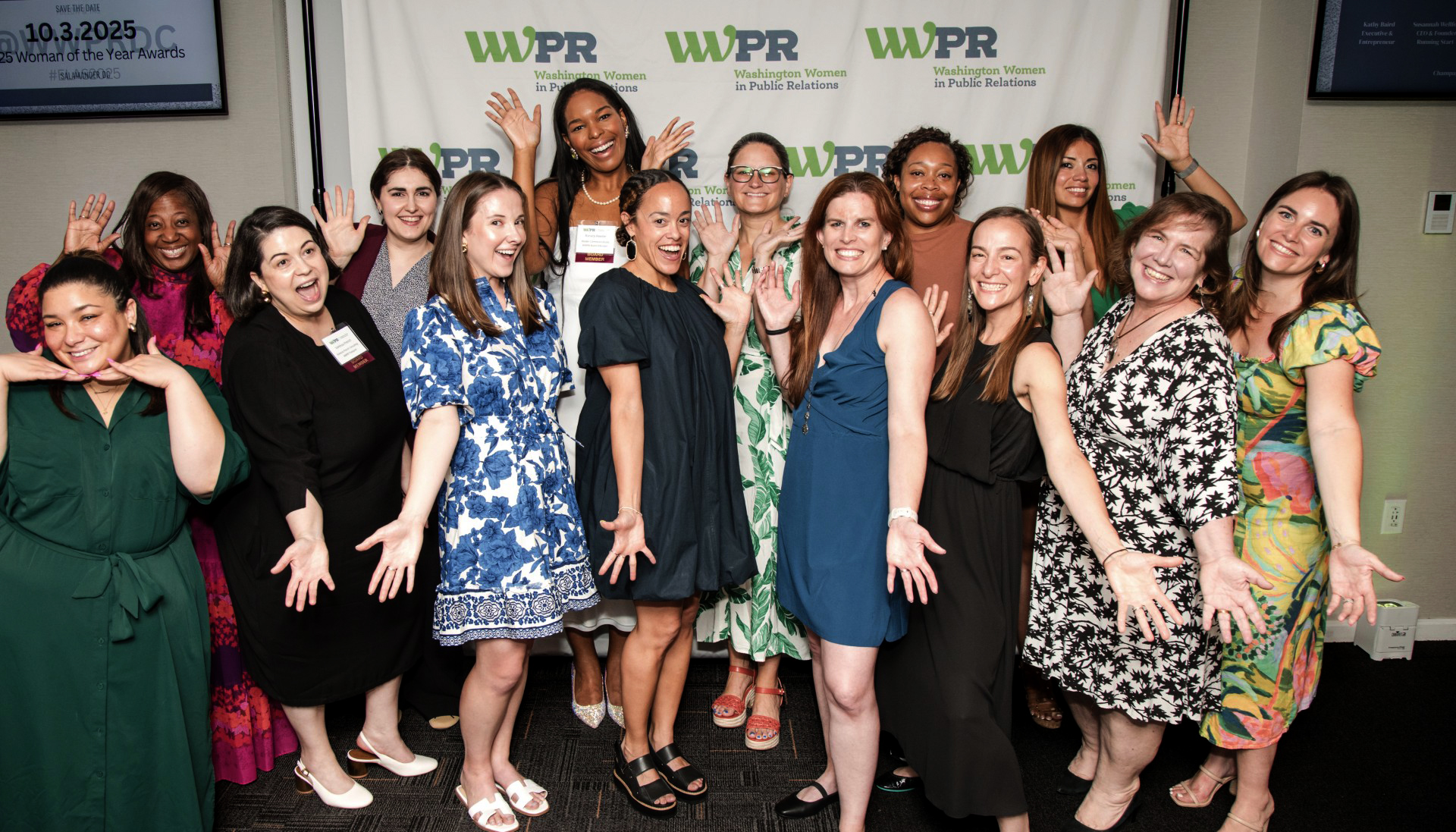 Many women smile and pose for the camera.